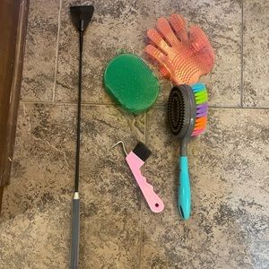 Various horse grooming supplies and jumping bat